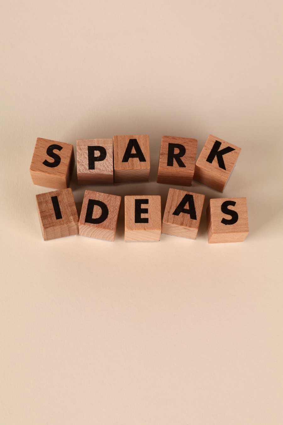 Wooden letter blocks spelling Spark Ideas