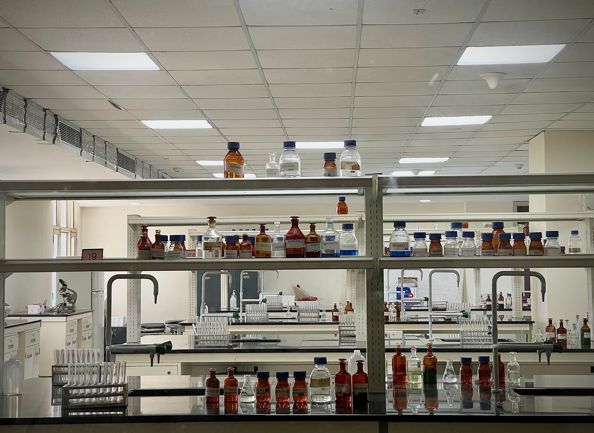 Laboratory bench with reagent bottles and glassware